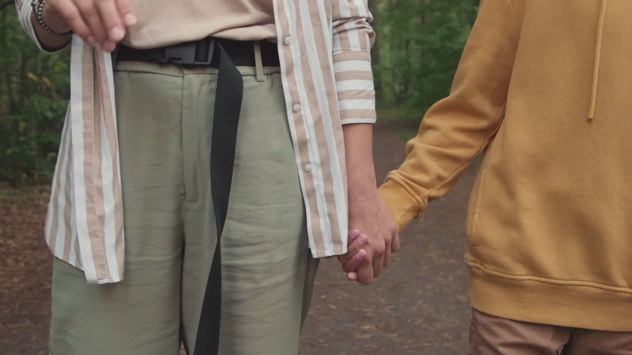 Unrecognizable Mom And Kid Holding Hands While Walking