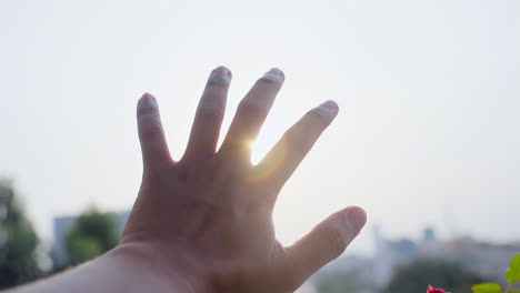 Man-stretches-out-his-hand-in-the-sun