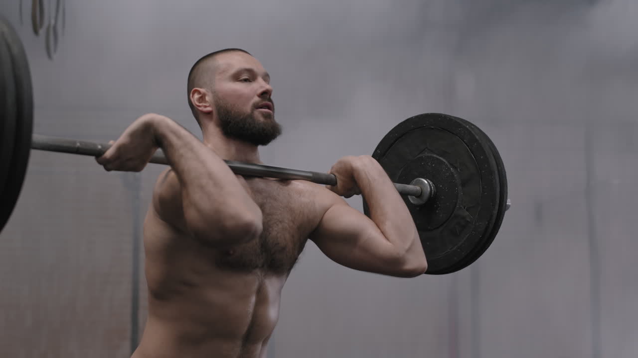 Male Powerlifter Squatting with Barbell