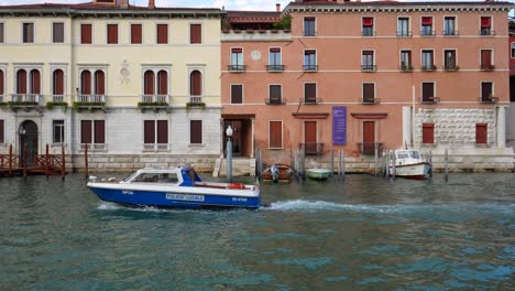 police boat in blinking lights in venice canal, italy