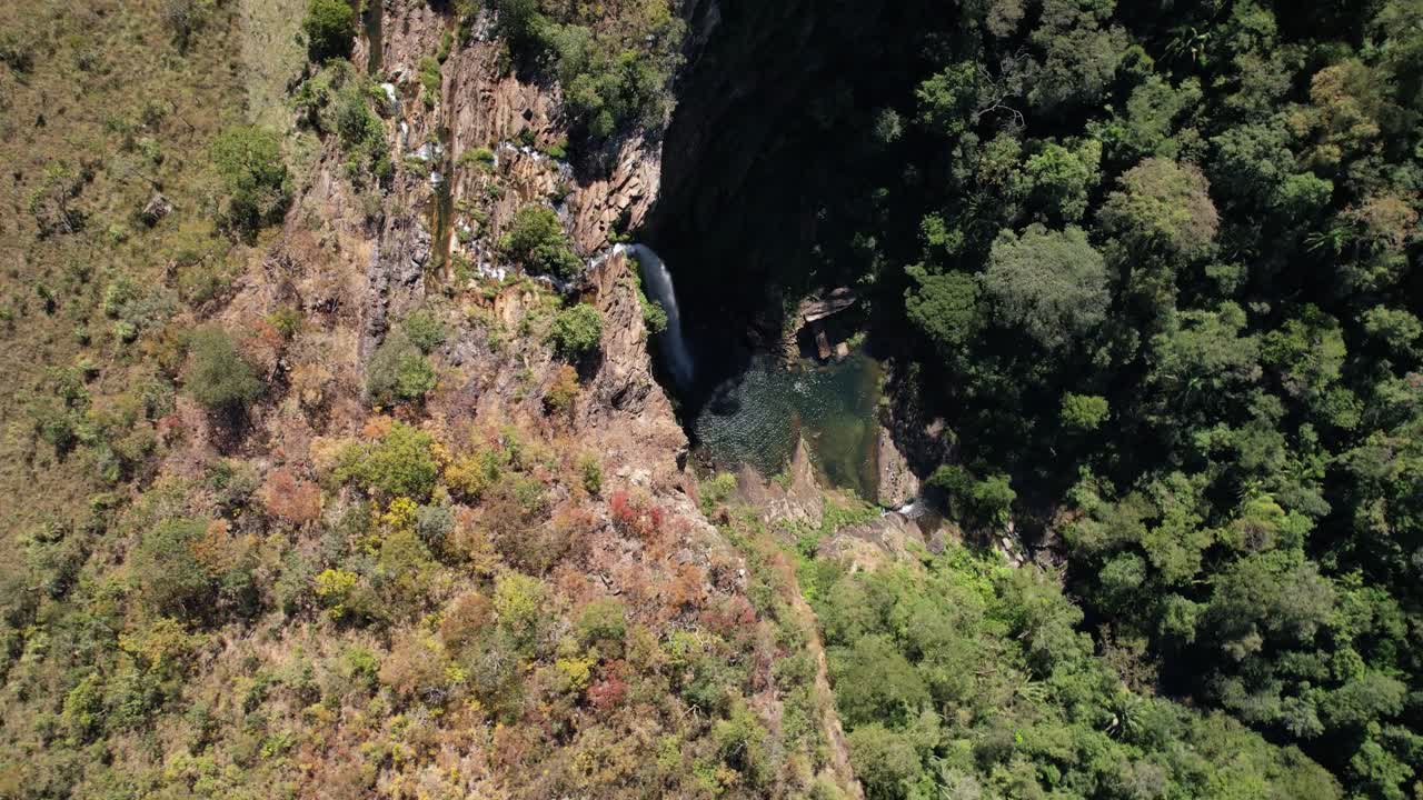 aerial video of waterfall in Chapada dos Veadeiros, Cachoeira Simão Correia, Alto Paraíso de Goiás, with rainbow, sunny day