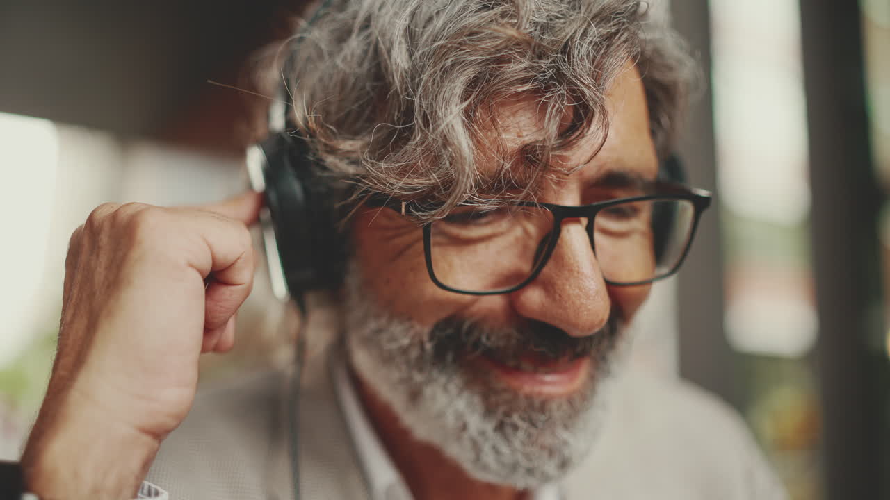 Older Man Listening to Music with Headphones