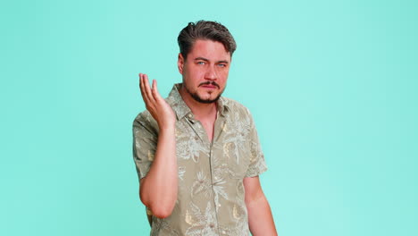 Adult man trying hear you looking confused and frowning keeping arm near ear for louder voice