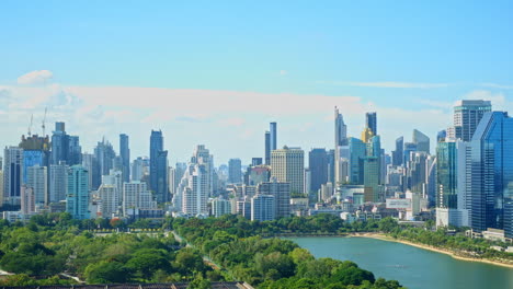 stationary time-lapse of downtown bangkok city skyline, cityscape, and the skyscrapers of the business district, benjakitti park, cti tower