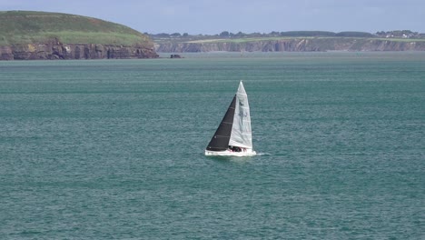 Yacht-sailing-home-to-harbour-at-Dunmore-East-Waterford-Ireland