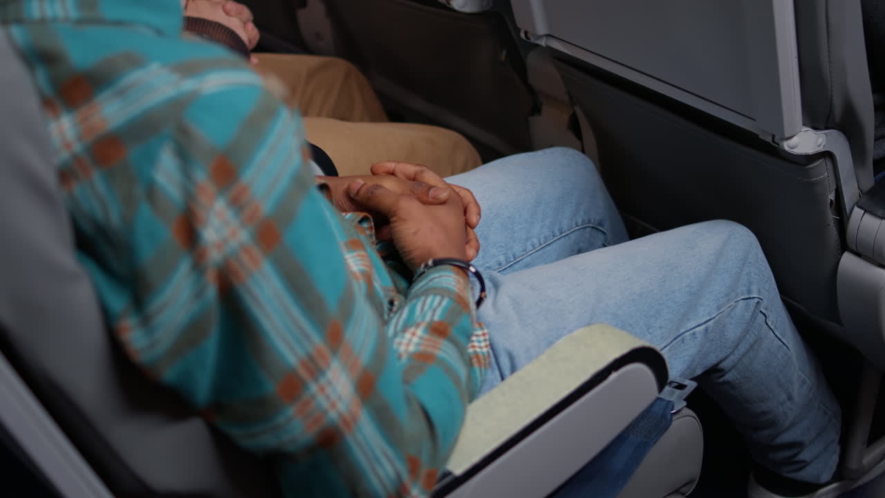 African american passenger fastening plane seatbelt for safety