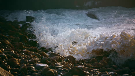 foaming sea splashing stones coastline in morning closeup. summer ocean weekend