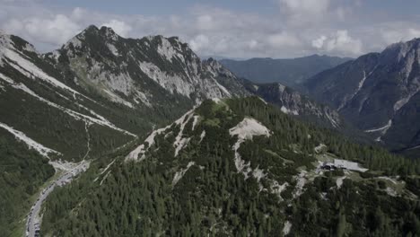 Drone-video-with-descriptive-frontal-shot-over-the-Vrsc-pass-in-Slovenia-with-mountains-on-the-horizon