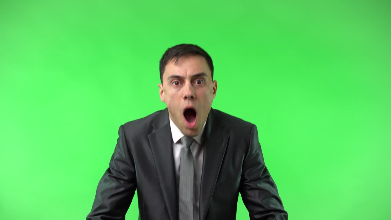 Man in suit with shocked expression on green screen