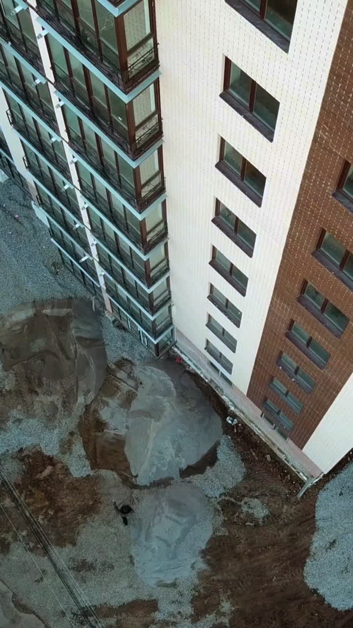 Newly constructed building. Aerial view of building construction site district Vertical video