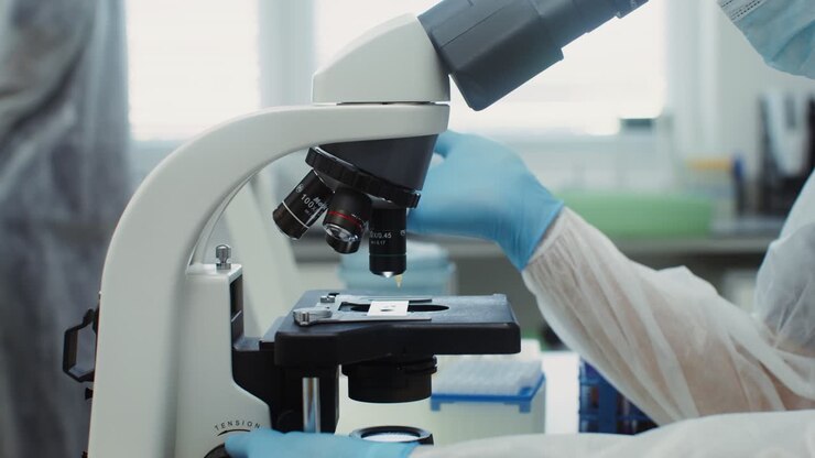 Scientist using microscope in laboratory
