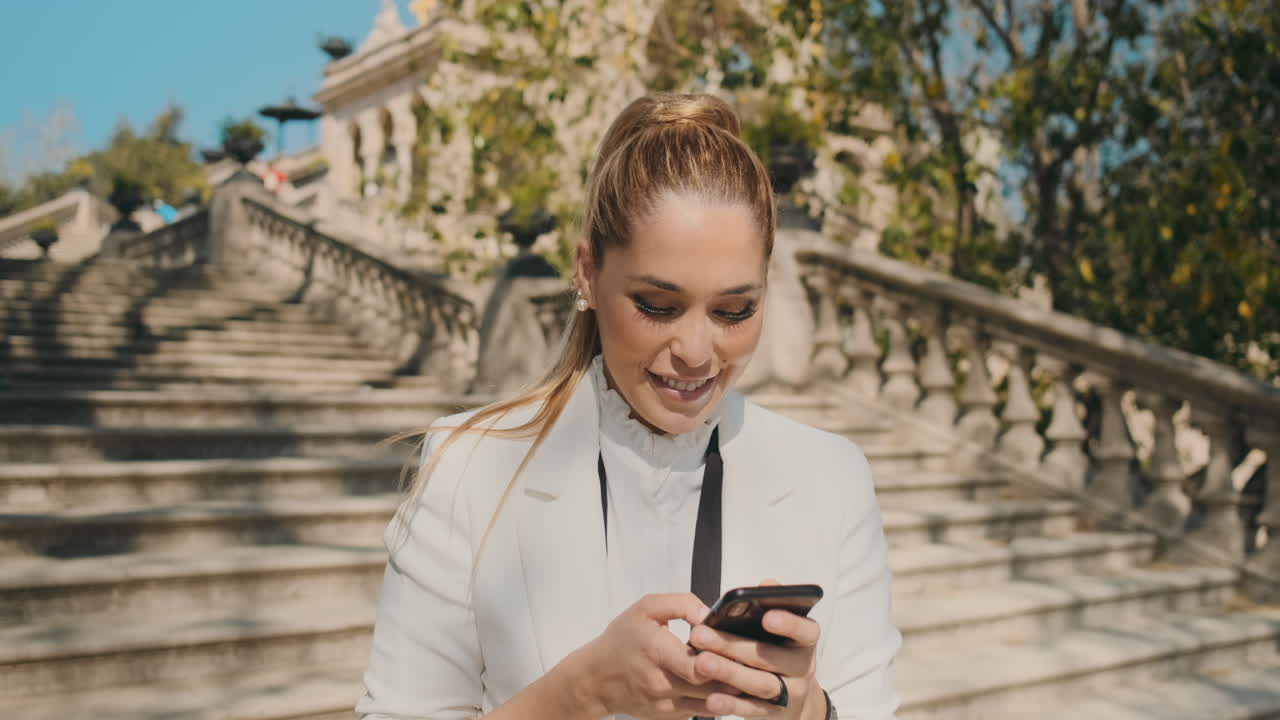 Stylish young woman calling on the phone outdoors.