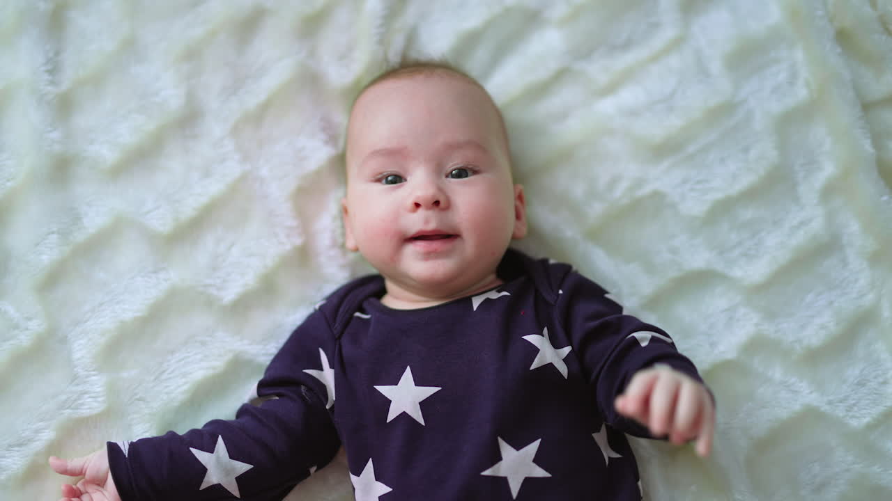 Baby lying down on a blanket