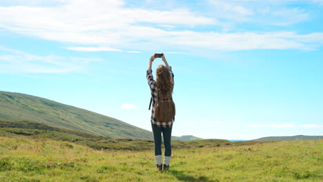 woman hiking and taking photos