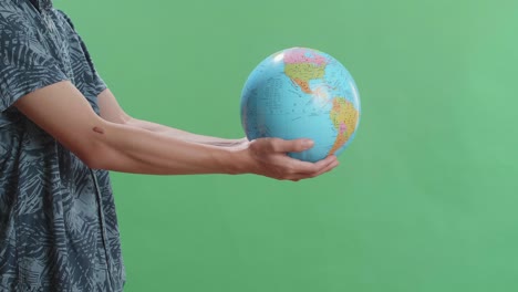 person holding a globe