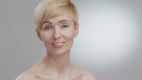 portrait of a smiling woman with short blonde hair