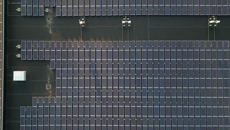 solar panel farm on rooftop of warehouse in usa. aerial top down flight. electricity theme. green energy. renewable energy.