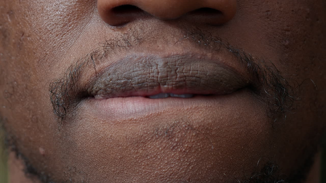 Macro shot of african american person moving his lips