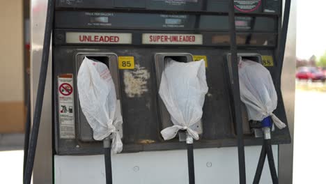 gas pumps at shut down fuel petrol station with plastic bags on all the nozzles due to gas shortage crisis and covid pandemic