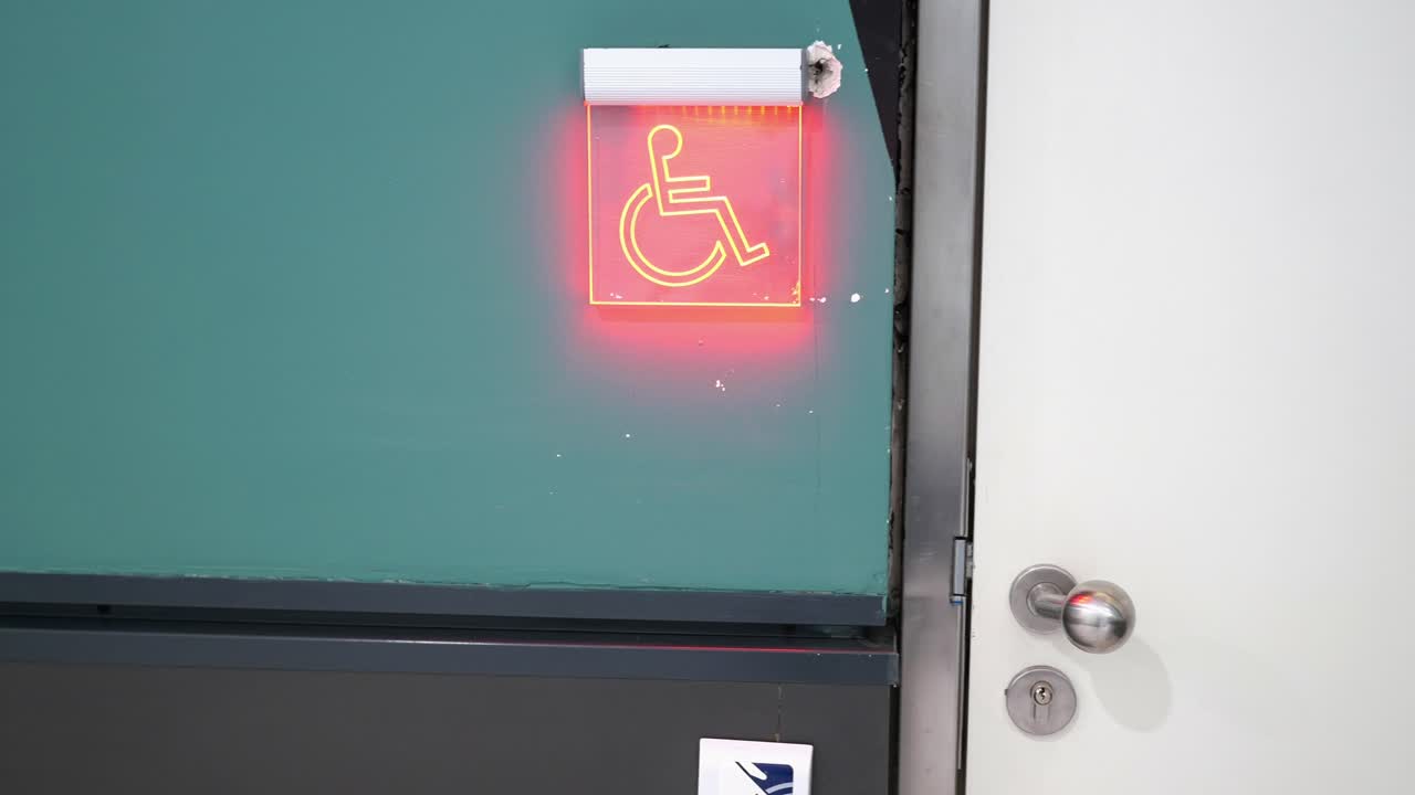 Accessible bathroom sign on a door
