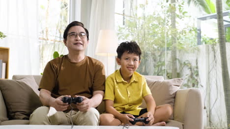 asian man and boy in the living room