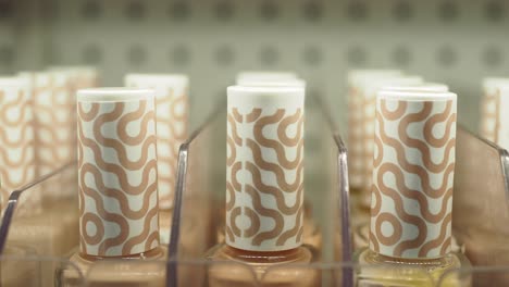 close-up of brown nail polish bottles on a shelf