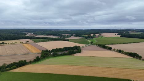 mystic clouds at sky of american countryside. farm fields and rolling hills in distance. quiet and peaceful landscape of united states. cultivated wheat and soybean fields. panorama aerial wide shot