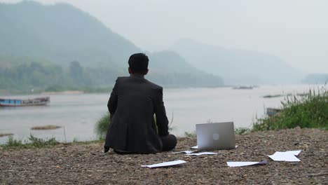 businessman relaxing by the river