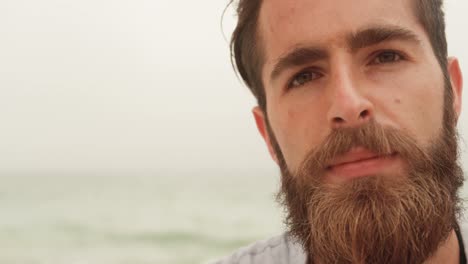 front view of caucasian man relaxing on the beach 4k