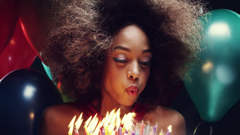 Beautiful-young-hispanic-woman-blowing-out-candles-celebrating-birthday-multicolored-balloon-background---Red-Epic-Dragon