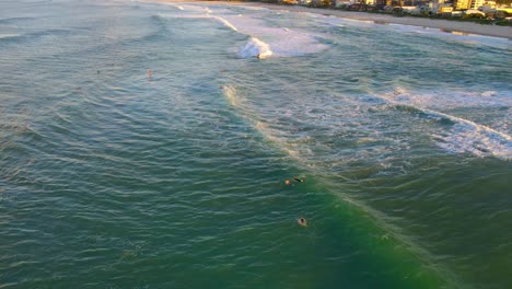 People-Surf-At-Blue-Ocean-Near-Palm-Beach-During-Golden-Hour---Surfing-At-QLD,-Australia