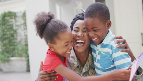 Animation-of-happy-african-american-soldier-mother-and-children-hugging-and-embracing