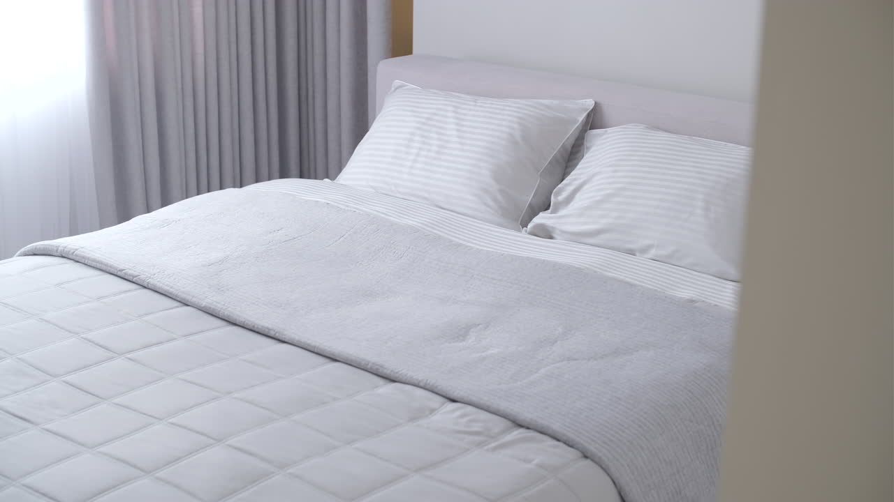 Clean and Comfortable Bed with White and Grey Bedding