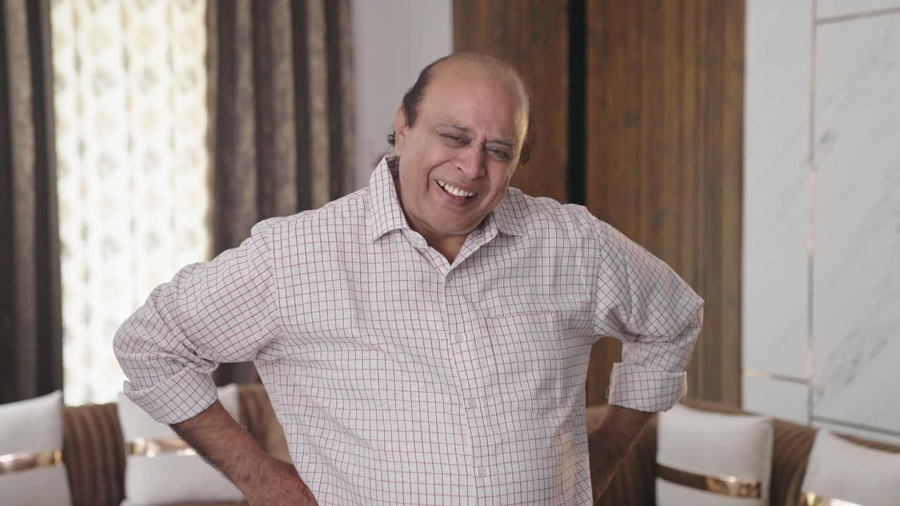 Old Indian fat man laughing at the camera