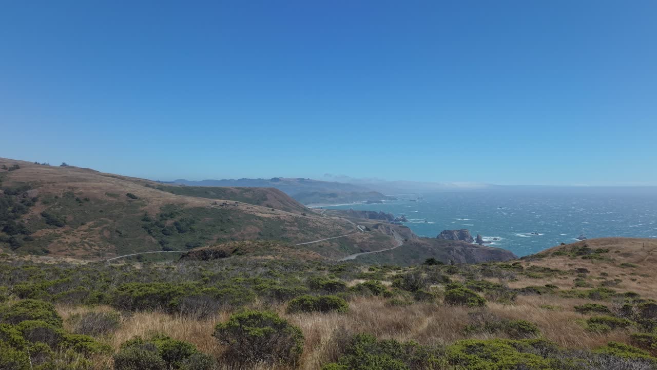 Drone pans over dramatic sea cliffs along the Sonoma Coast, where land meets ocean in raw harmony