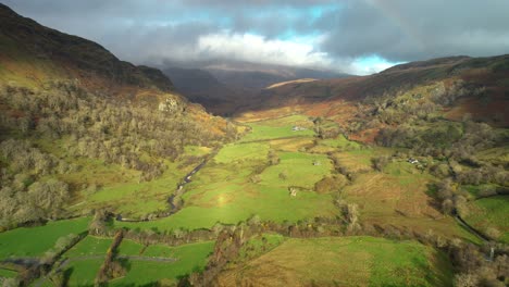 green fields and mountain landscape of snowdonia wales - aerial shot