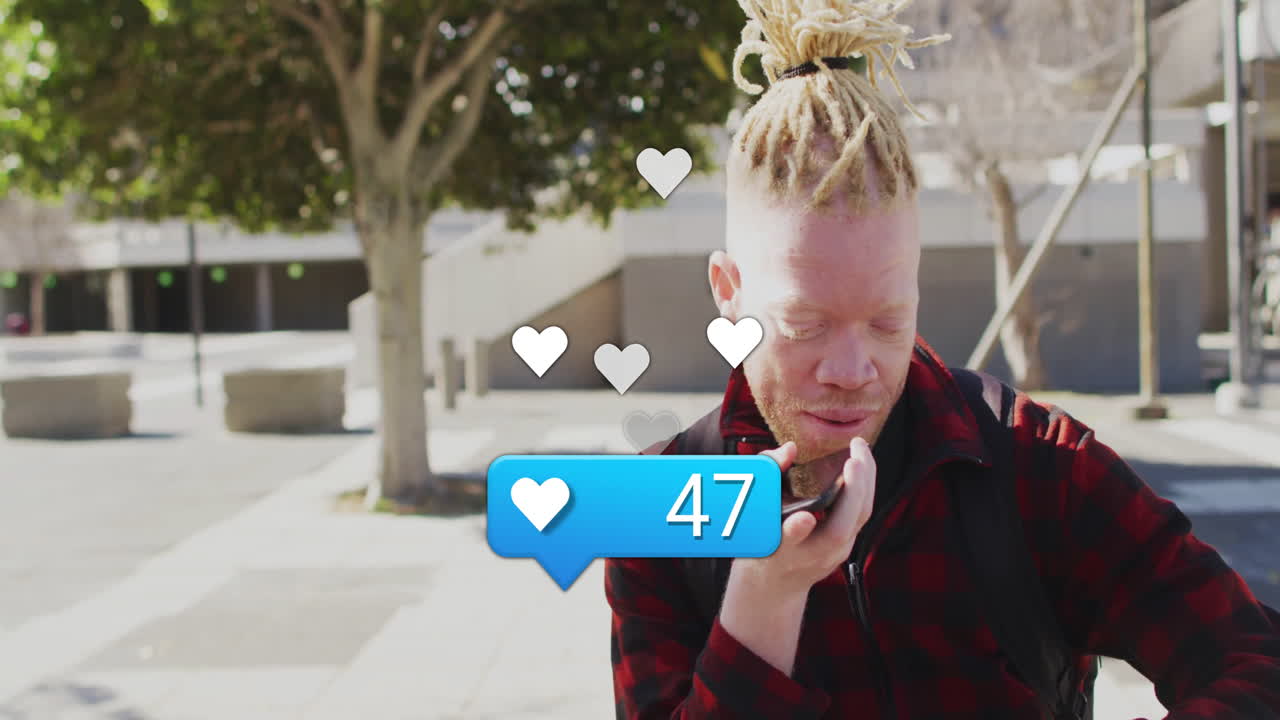 Using phone outdoors, person with dreadlocks surrounded by animation of hearts
