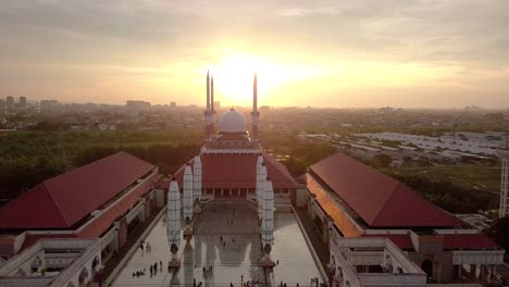 aerial view of the great mosque of central java (majt) in suset time. th sun is orange and the weather is cloudy.