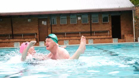 Senior-man-carrying-woman-in-swimming-pool