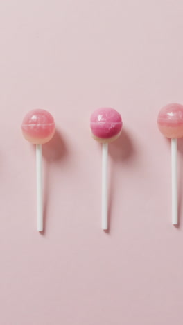 video of pink lollipops on pink background