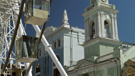 tilt down st catherine church kiev framed by podil ferris wheel