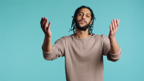 Man-blowing-kisses-to-camera,-being-flirty,-studio-background