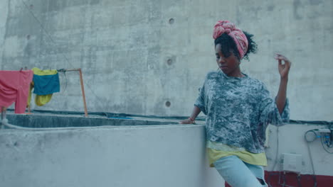 sensual black woman practicing tango dance on a wet rooftop