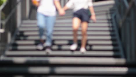 two people ascending stairs in unison