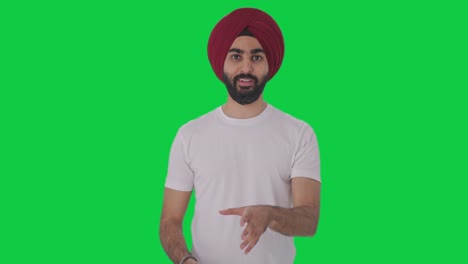 happy sikh indian man talking green screen