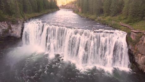 drone aerial close up of the upper mesa falls, a thunderous curtain of water – as tall as a 10-story building near island park, and ashton, idaho