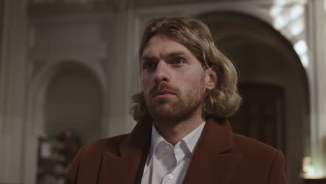 young caucasian man crossing himself in christian church