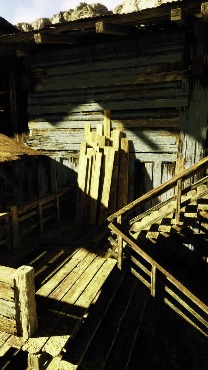 Old wooden structure amidst rocky landscape during bright daylight hours