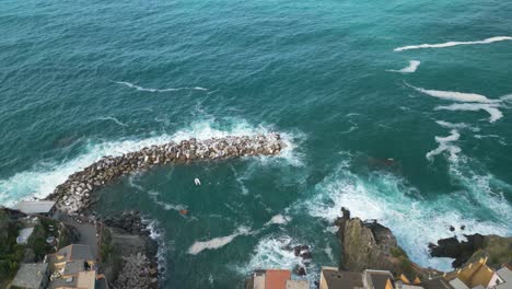 aerial pullback reveals tourist town in italy's cinque terre village