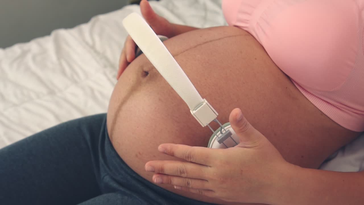 Happy pregnant woman and expecting baby at home.